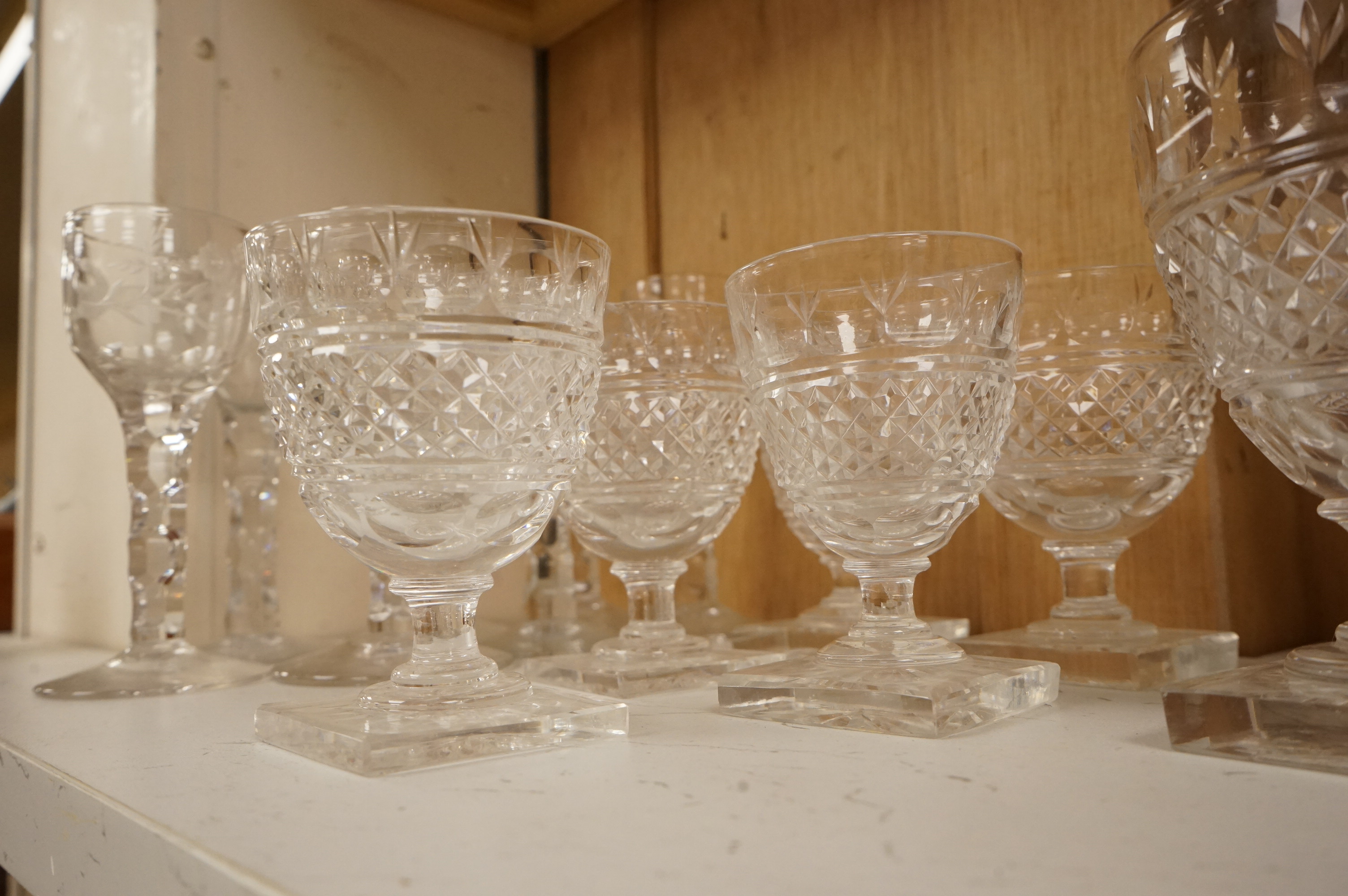Seven Georgian style facet stem engraved wine glasses and a part suite of 19th centuy rummers, largest 14cm high